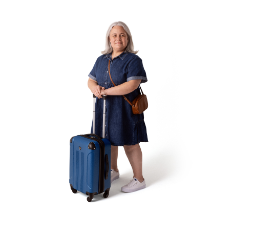 A woman standing with a suitcase