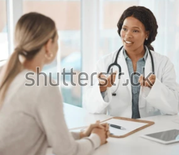 A woman consulting with a doctor in a medical office 