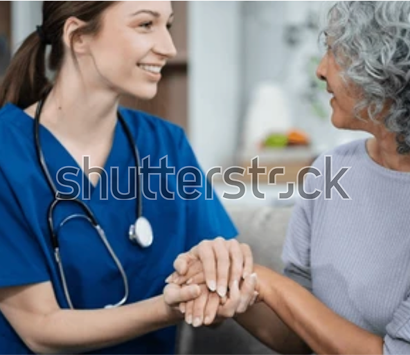 A woman and a doctor holding hands as they gaze at each other